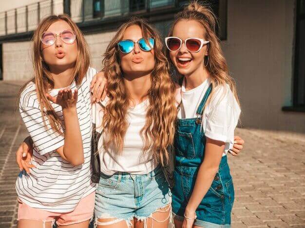 Teenagers in sunglasses smiling